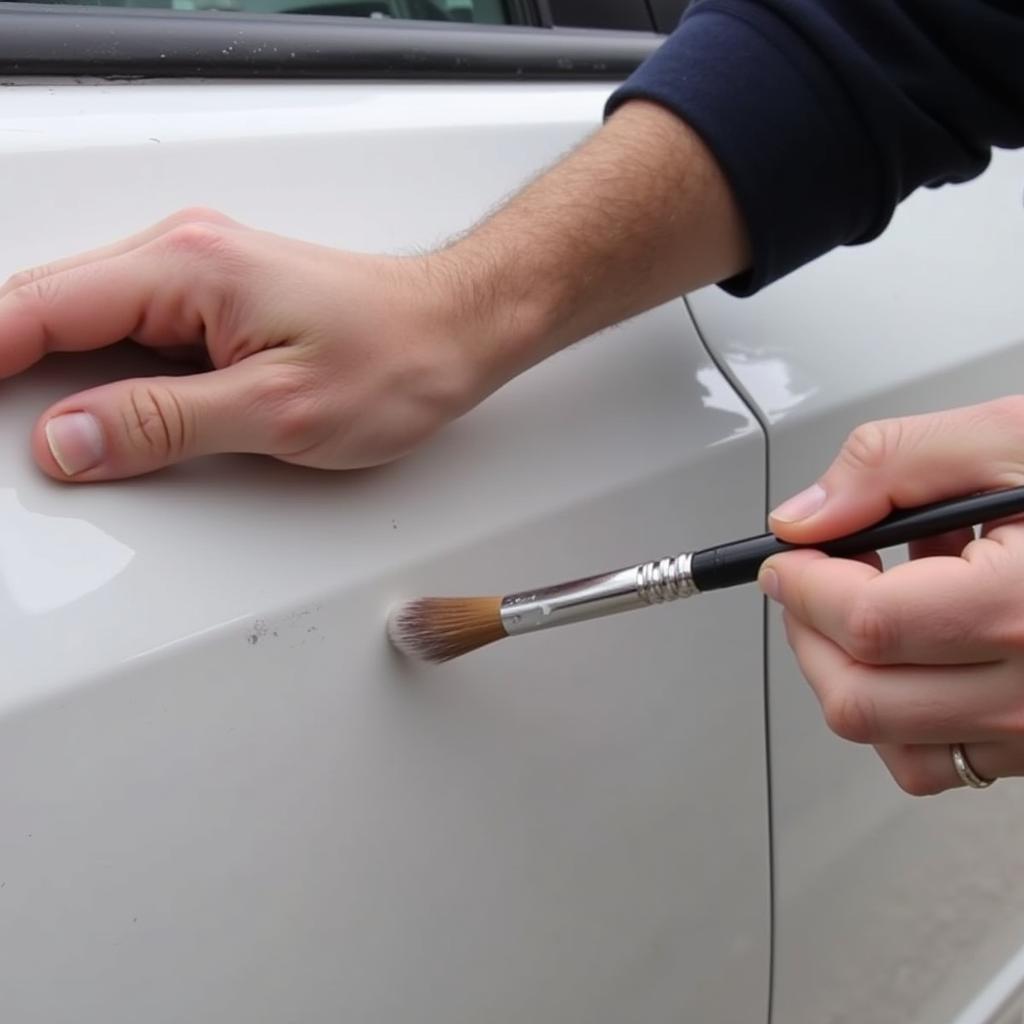 Applying touch-up paint to a car scratch