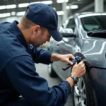 Skilled auto body technician inspecting damage on a car