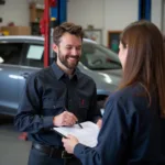 A mechanic discussing an auto repair estimate with a car owner