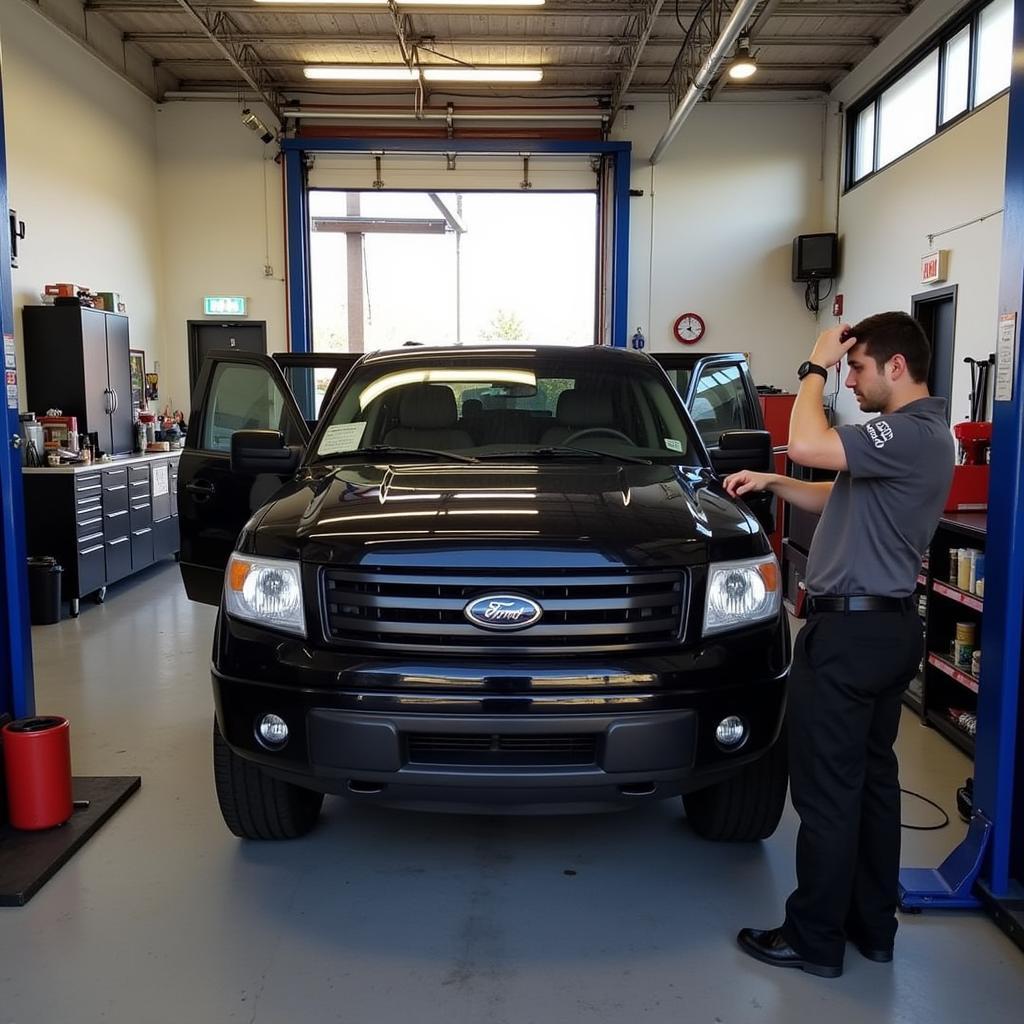 Mechanic inspecting a car in an auto repair shop on School House Rd, Whiting NJ