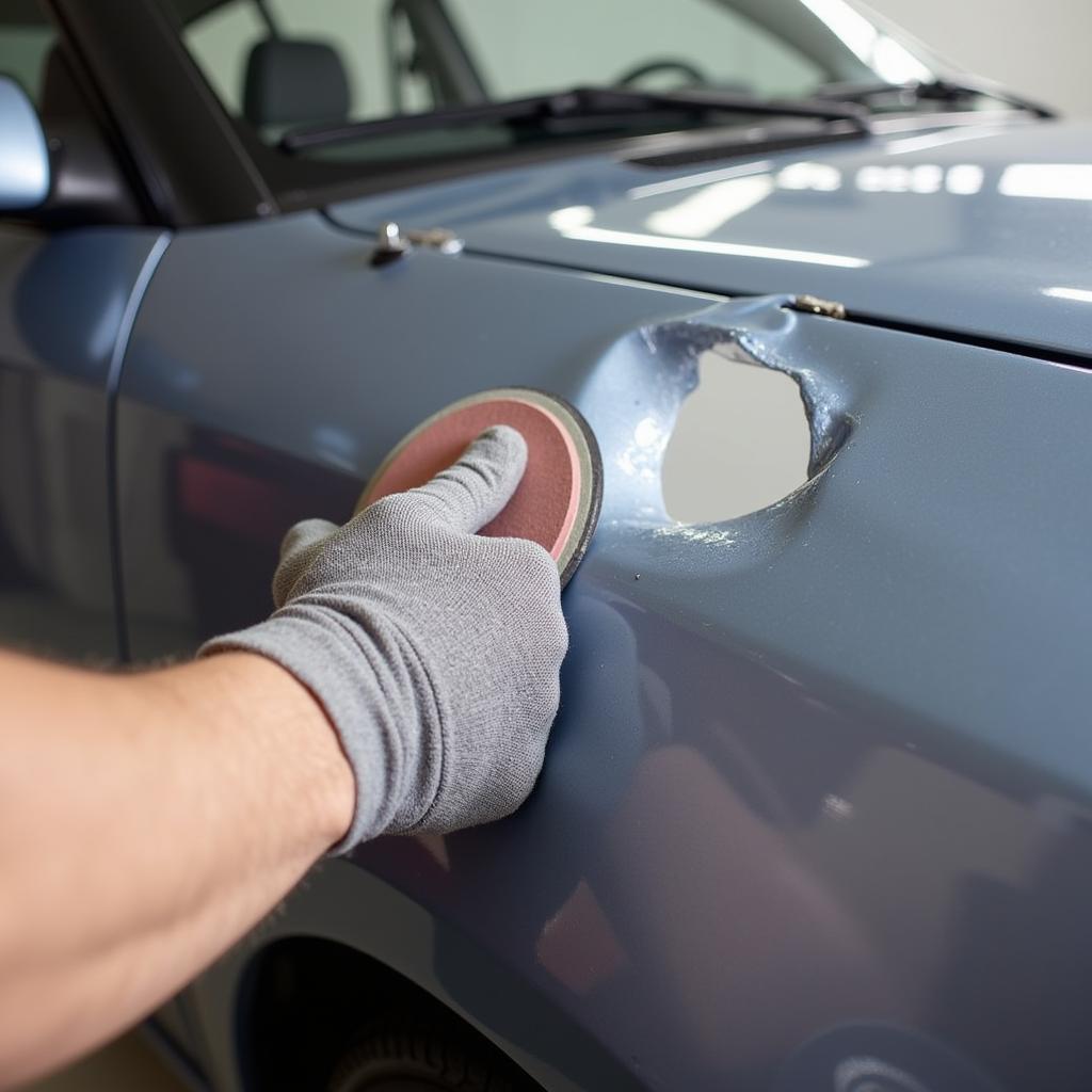 Sanding the Damaged Area of Car Body for Repair