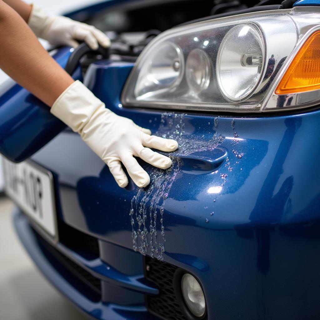 Repairing a minor dent in a car bumper with hot water