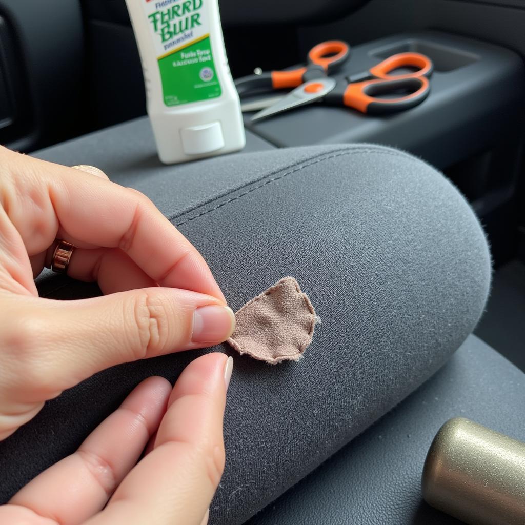 Repairing a small tear in fabric car seat with a patch