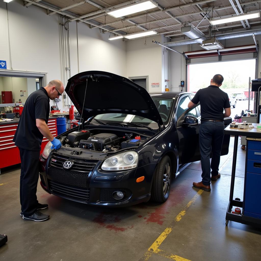 Auto body repair shop in New Jersey with mechanics working on a damaged car.