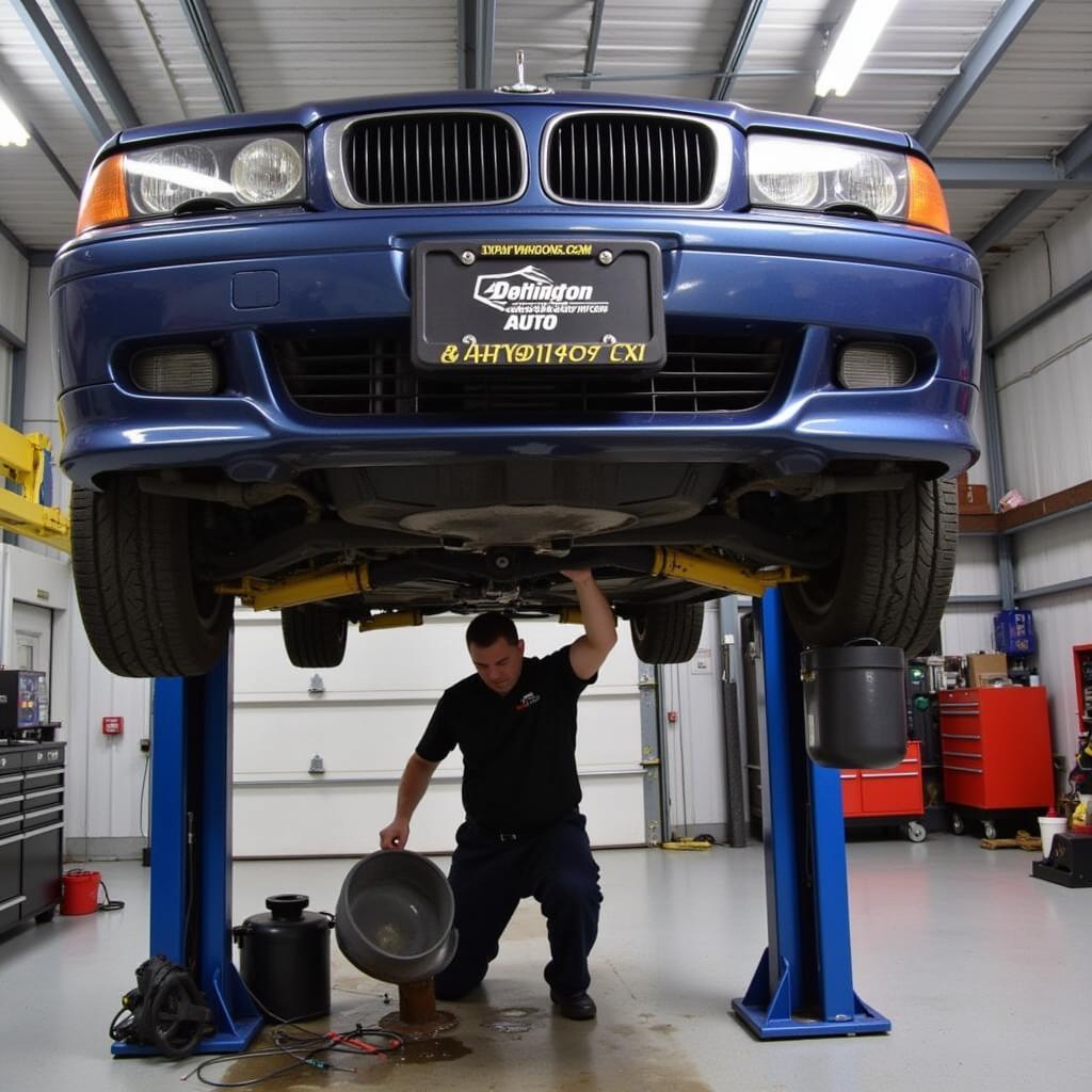 Car undergoing an oil change in a Warrington auto service center