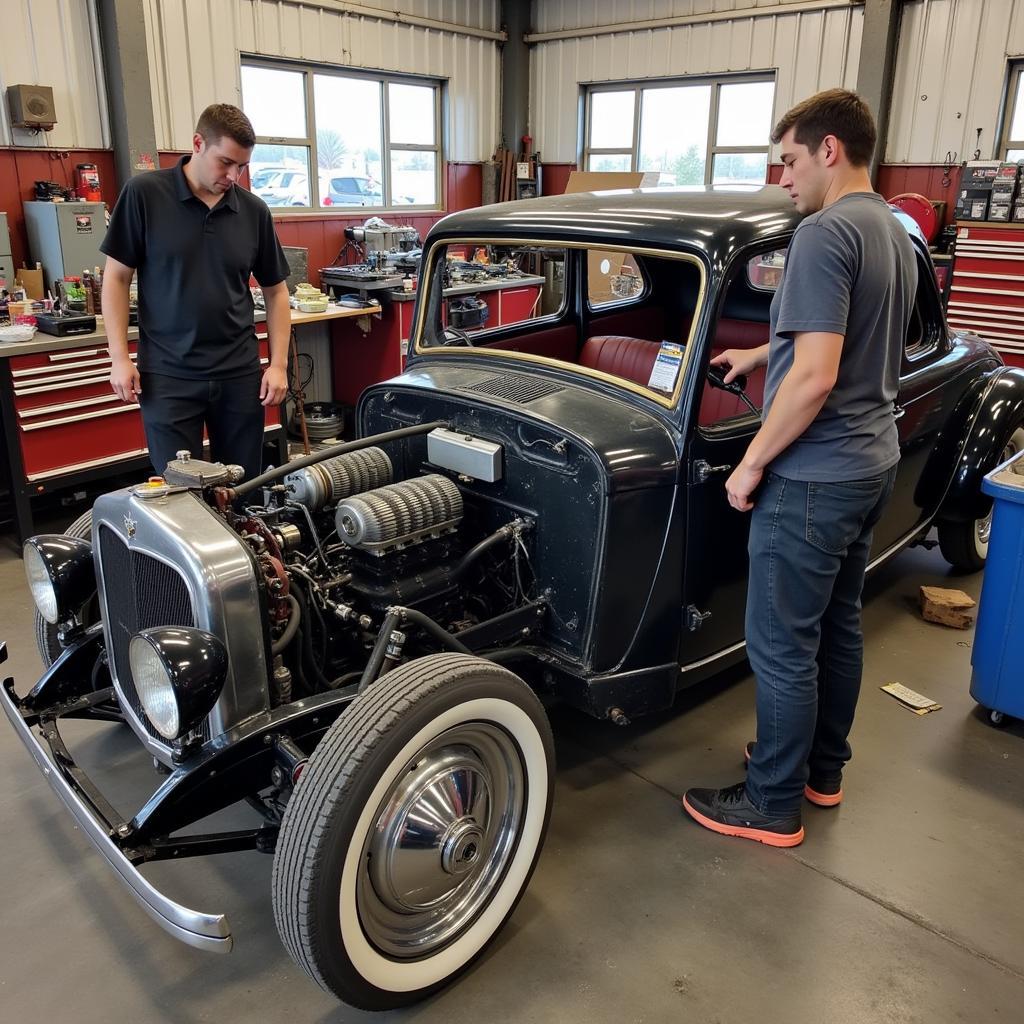 Classic Car Disassembly Process - Mechanics disassembling a vintage car for restoration in Haysville.