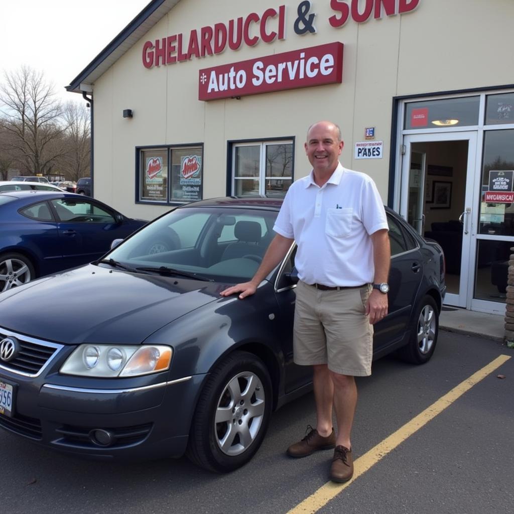 A satisfied customer standing next to their repaired car at Ghelarducci & Sons Auto Service.