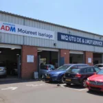 Modern and well-equipped ADM auto service & MOT centre exterior with customer vehicles parked outside.