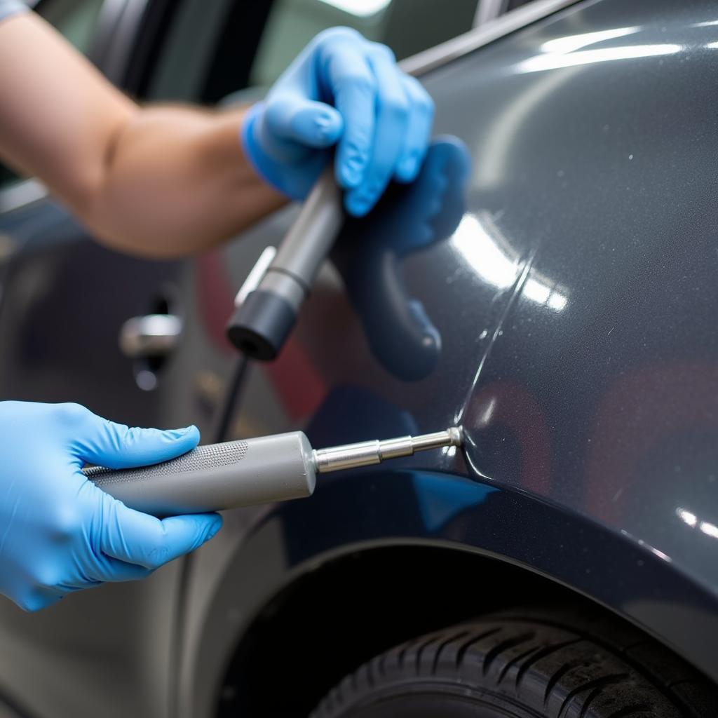 Auto Hail Repair Technician Working on Dent