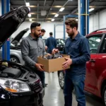 Auto parts runner delivering parts directly to a busy mechanic in a repair shop