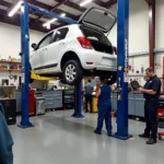 Car on a lift undergoing repair in a professional auto service center