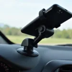 A car mobile holder with a loose joint causing it to wobble.