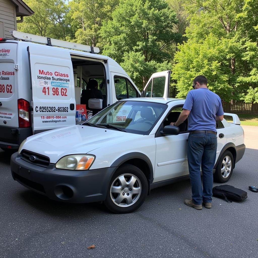 A mobile auto glass repair van parked in a driveway in Prince Georges County, with a technician repairing a car windshield.