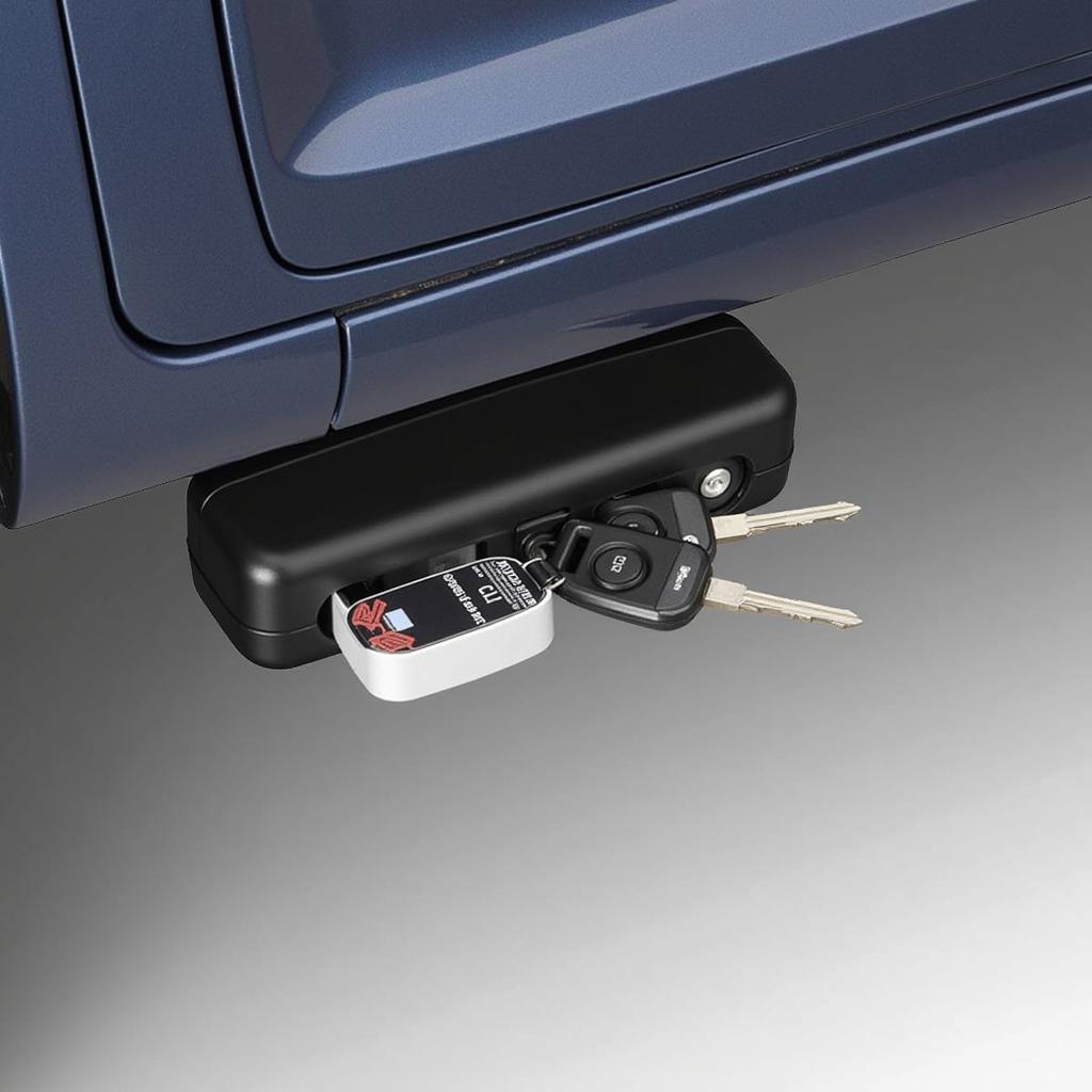 A spare car key securely hidden in a magnetic box attached to the underside of a car.