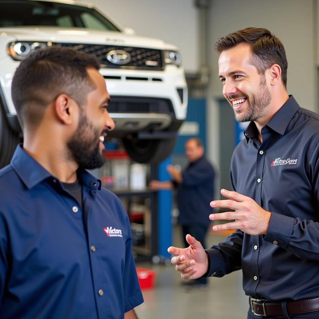 Customer interacting with a friendly service advisor at Victory Auto Service & Glass