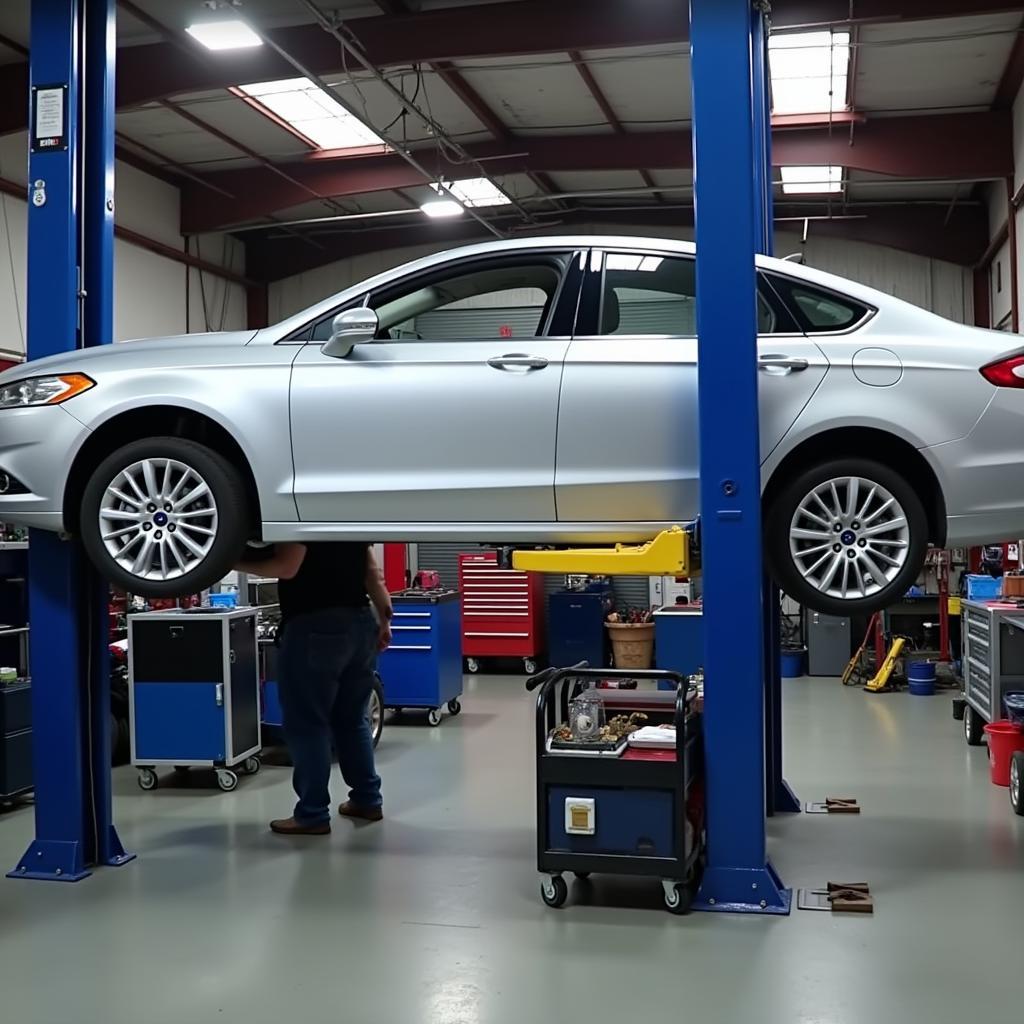 Car on a lift in an auto repair shop for routine maintenance